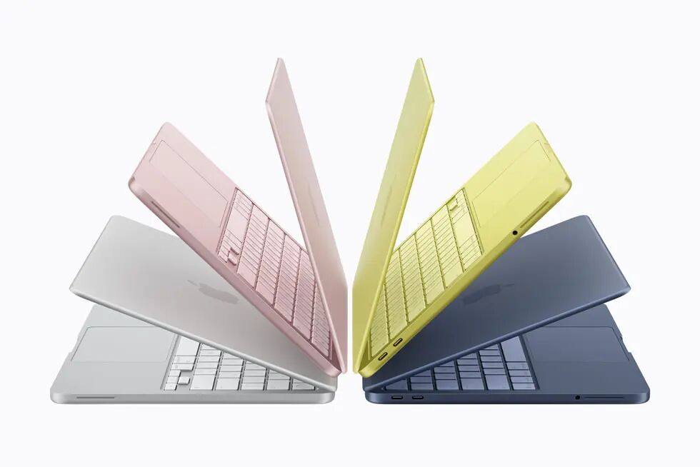 扇形排开的几台 MacBook Neo 展示四种机身外观：银色、桃粉色、柑橘黄色和靛蓝色。